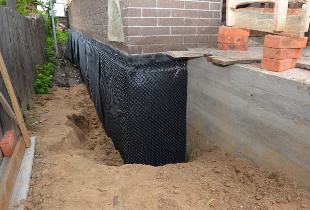 Happy homeowners after waterproofing job in Chase